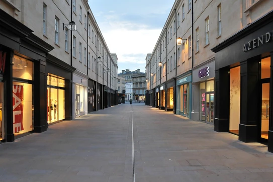 An empty strip of stores with no shoppers in sight