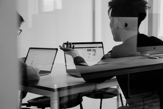 people collaborating in front of laptops 