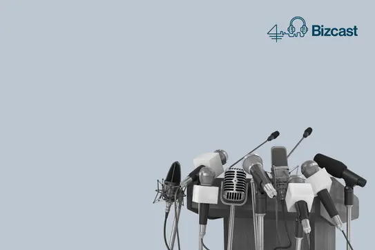 An empty podium surrounded by many microphones