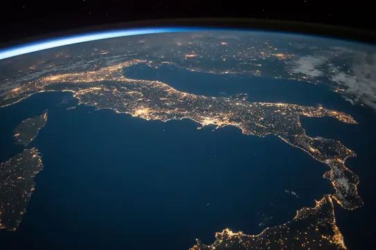 Earth Day Image displaying the globe with city lights