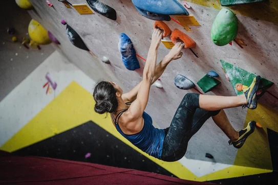 A women indoor rock climbing.